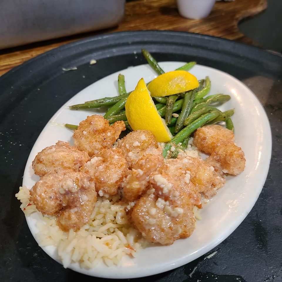 A plate of food with rice and green beans.