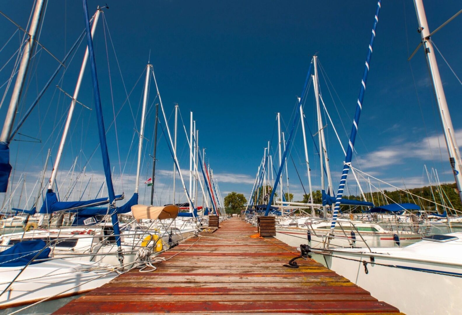 A dock with many boats tied to it.