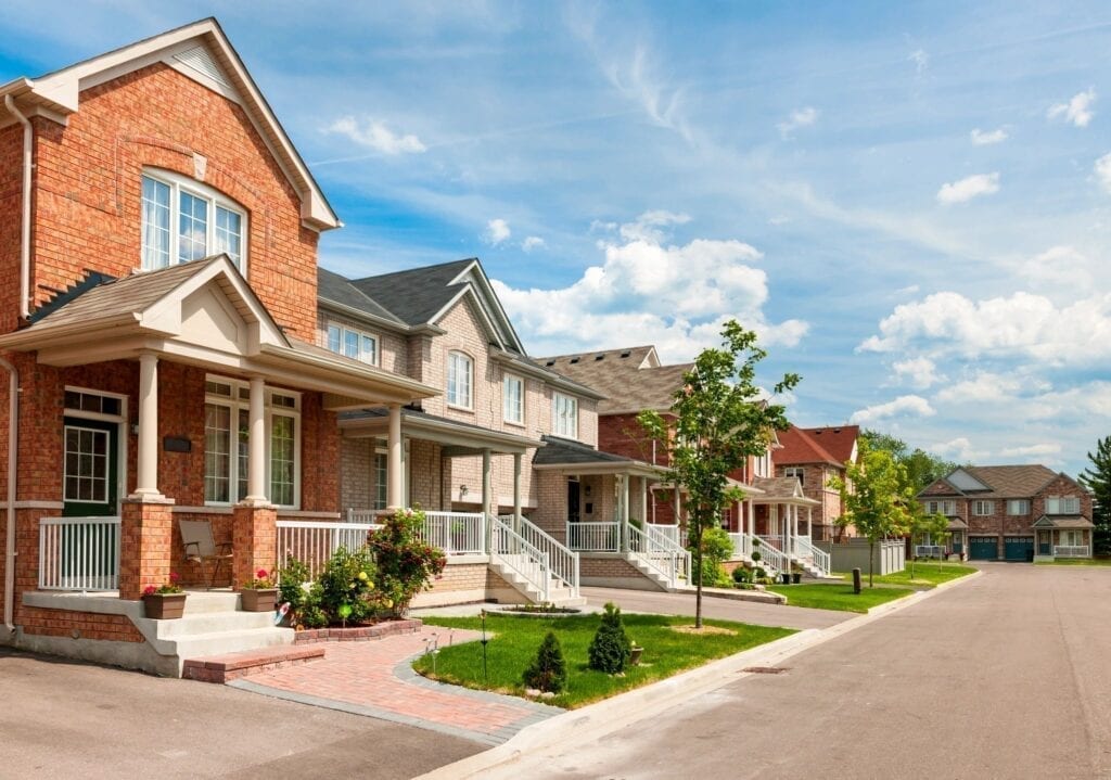 A row of houses on the side of a street.