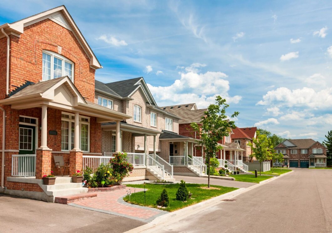 A row of houses on the side of a street.