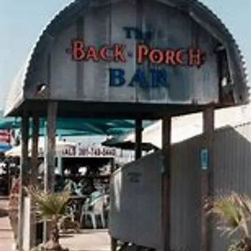 A sign for the back porch bar in front of an outdoor restaurant.