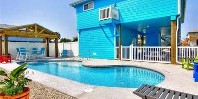 A pool with blue walls and a white fence.