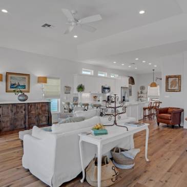 A living room filled with furniture and a ceiling fan.