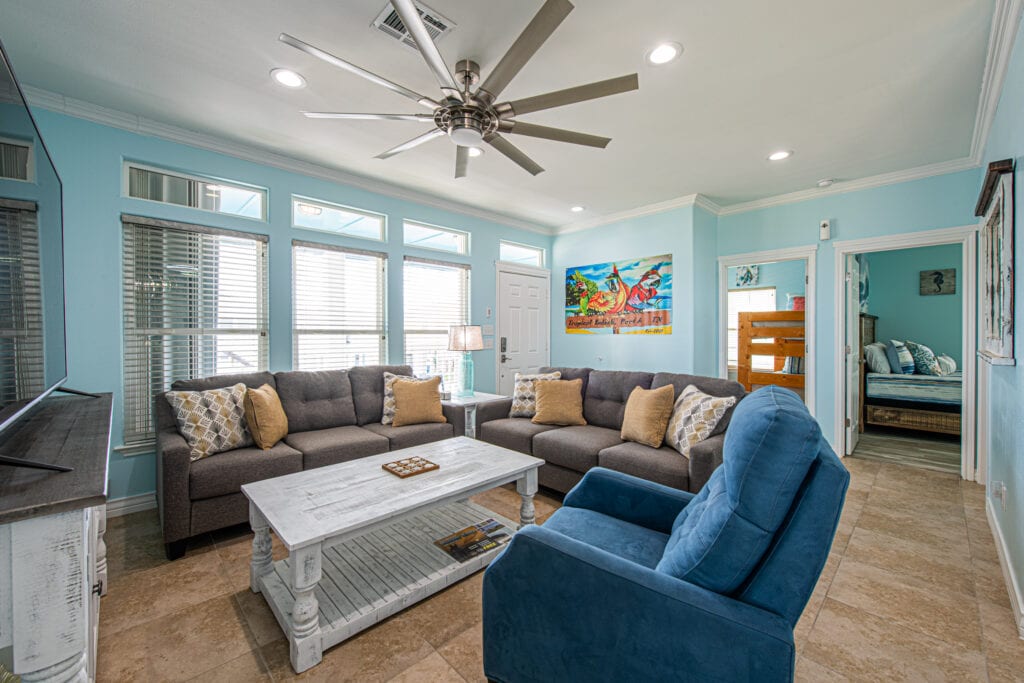 A living room with couches, chairs and a coffee table.