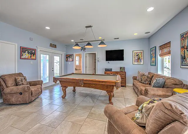 A living room with couches, a table and a television.