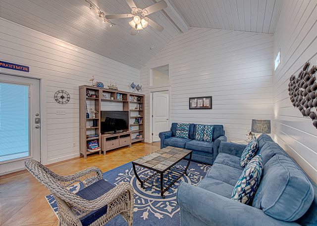 A living room with blue furniture and white walls.